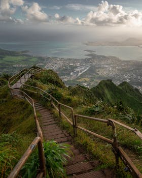 Breathtaking view from the iconic Haiku Stairs in Honolulu, offering sweeping vistas of lush landscapes and ocean. Perfect for travel enthusiasts.