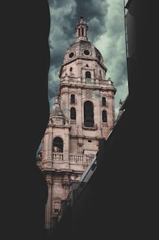 Stunning view of the Cathedral of Murcia against a dramatic sky, showcasing its architectural elegance.