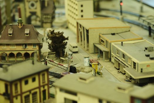 Intricate model town showcasing buildings and a railway track in a miniature setting.