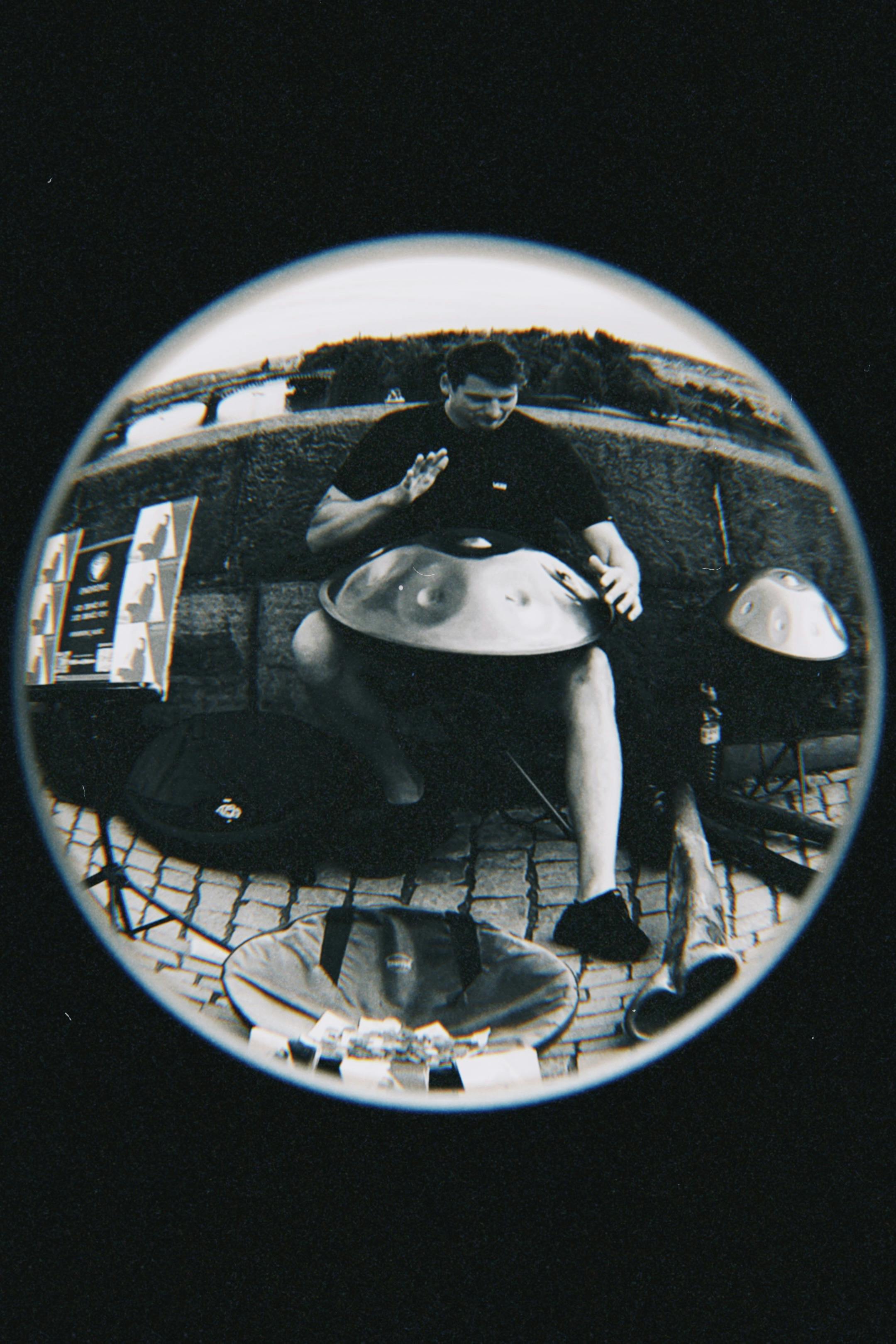 Street musician performs with a handpan in Prague's historic district.