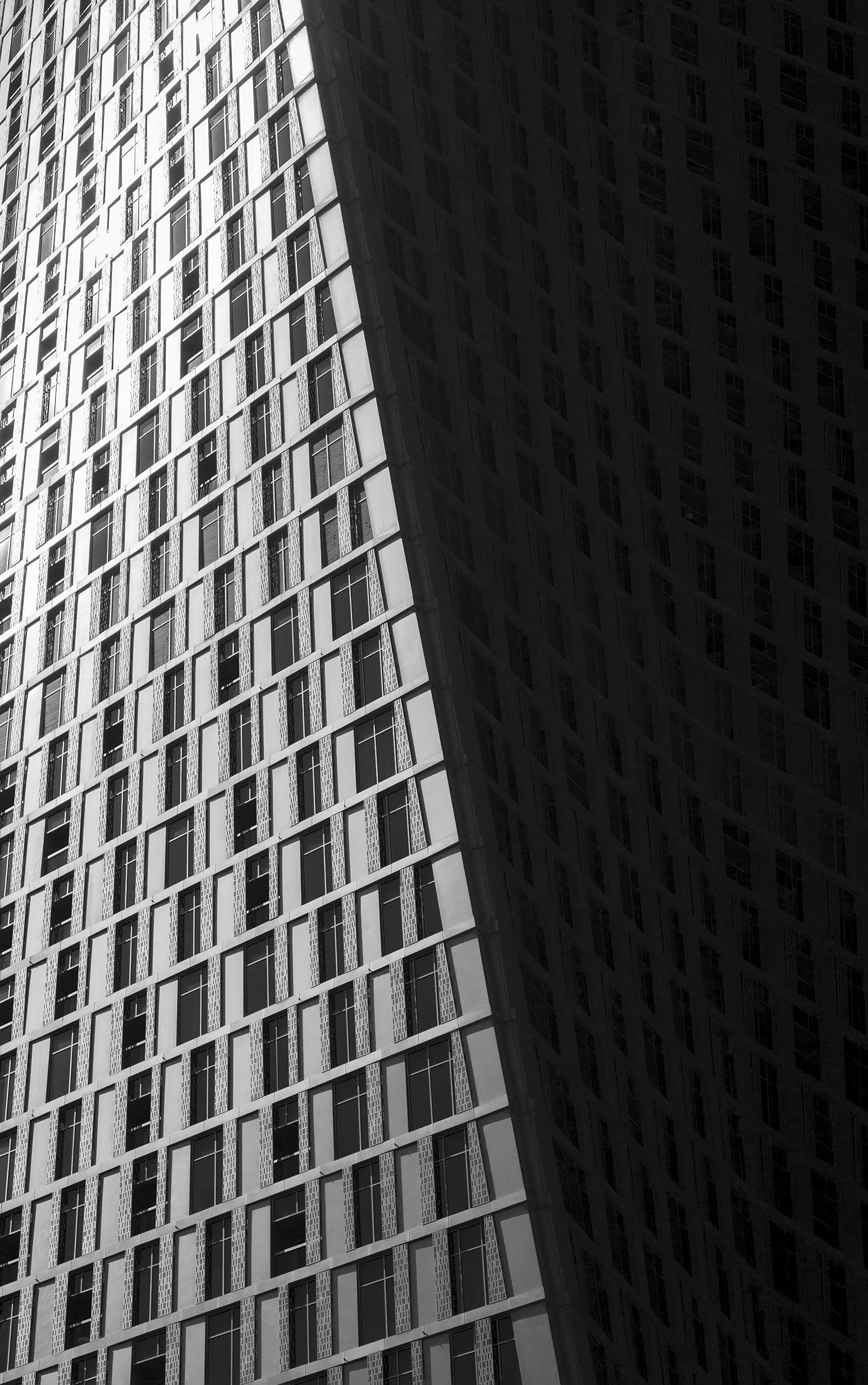 Black and white abstract view of a modern skyscraper facade in Dubai, UAE.