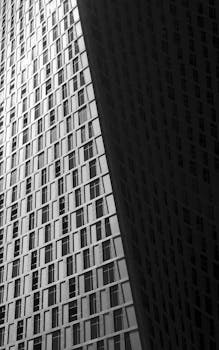 Black and white abstract view of a modern skyscraper facade in Dubai, UAE.