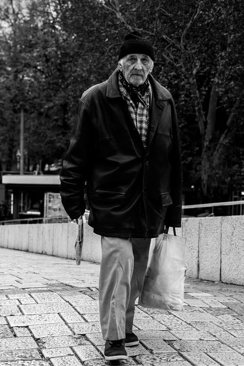 Free Black and white portrait of an elderly man walking in Sarajevo, Bosnia. Stock Photo
