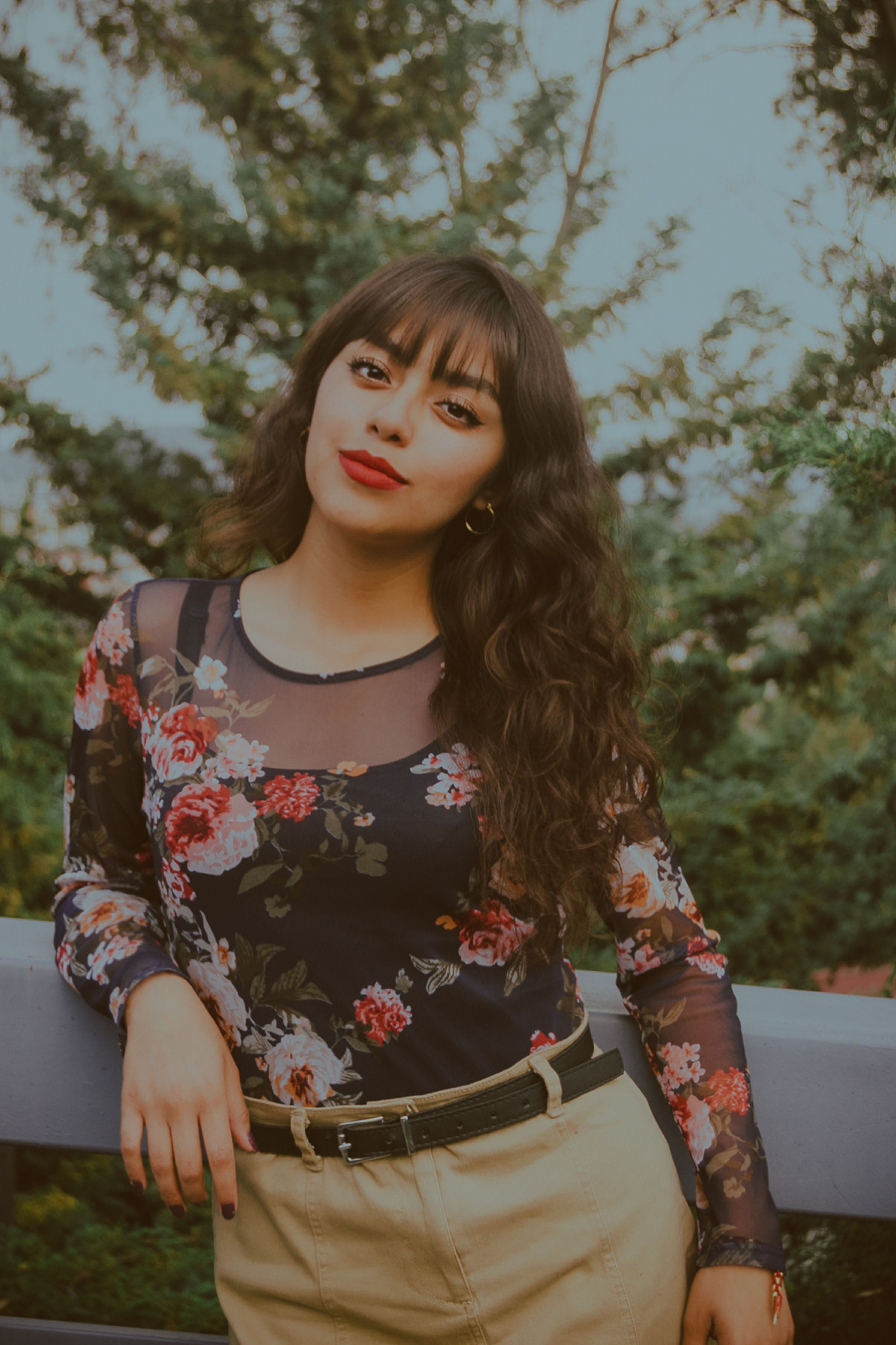Young Woman in Floral Top Outdoors with Trees · Free Stock Photo