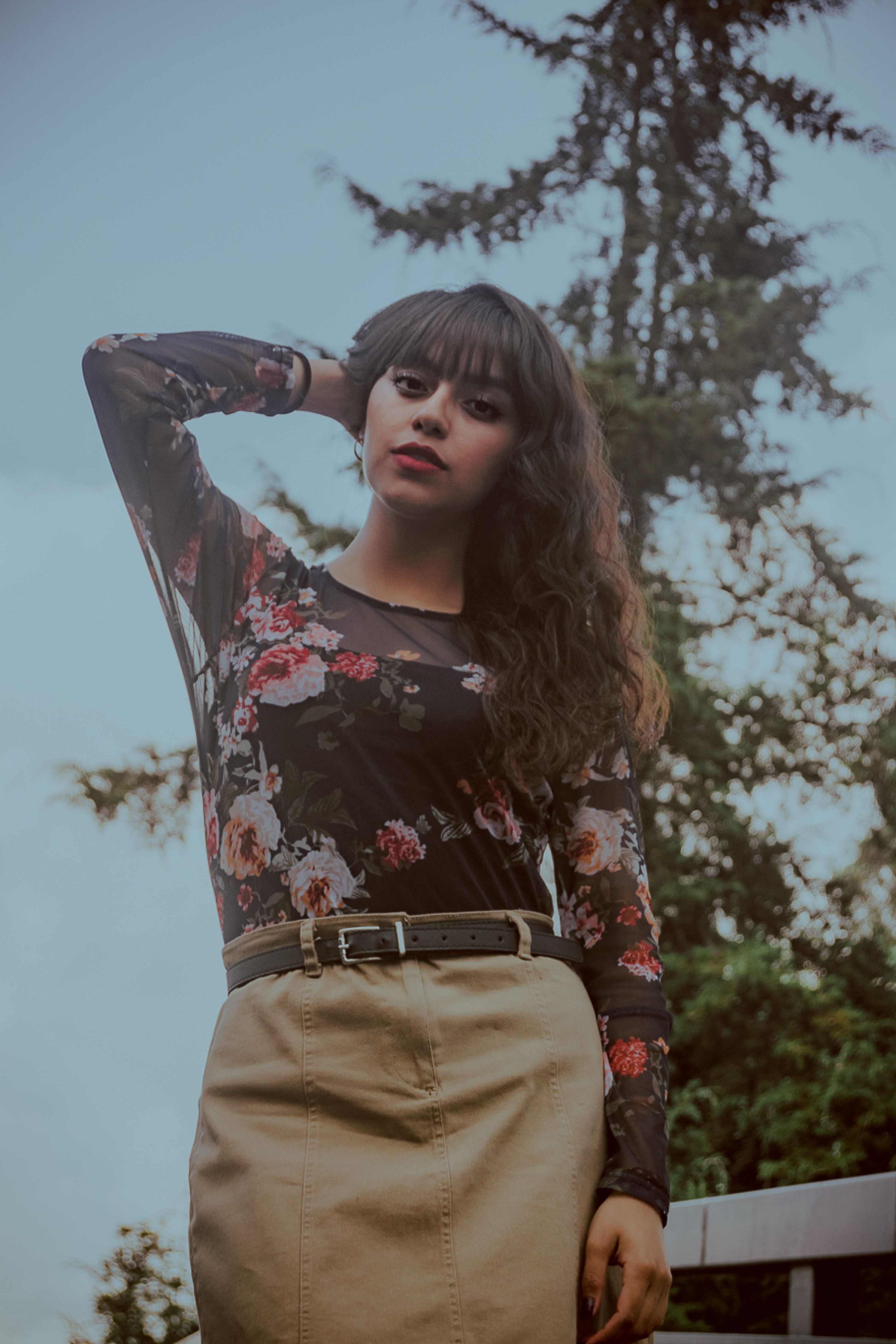 Stylish Woman in Floral Top Posing Outdoors · Free Stock Photo