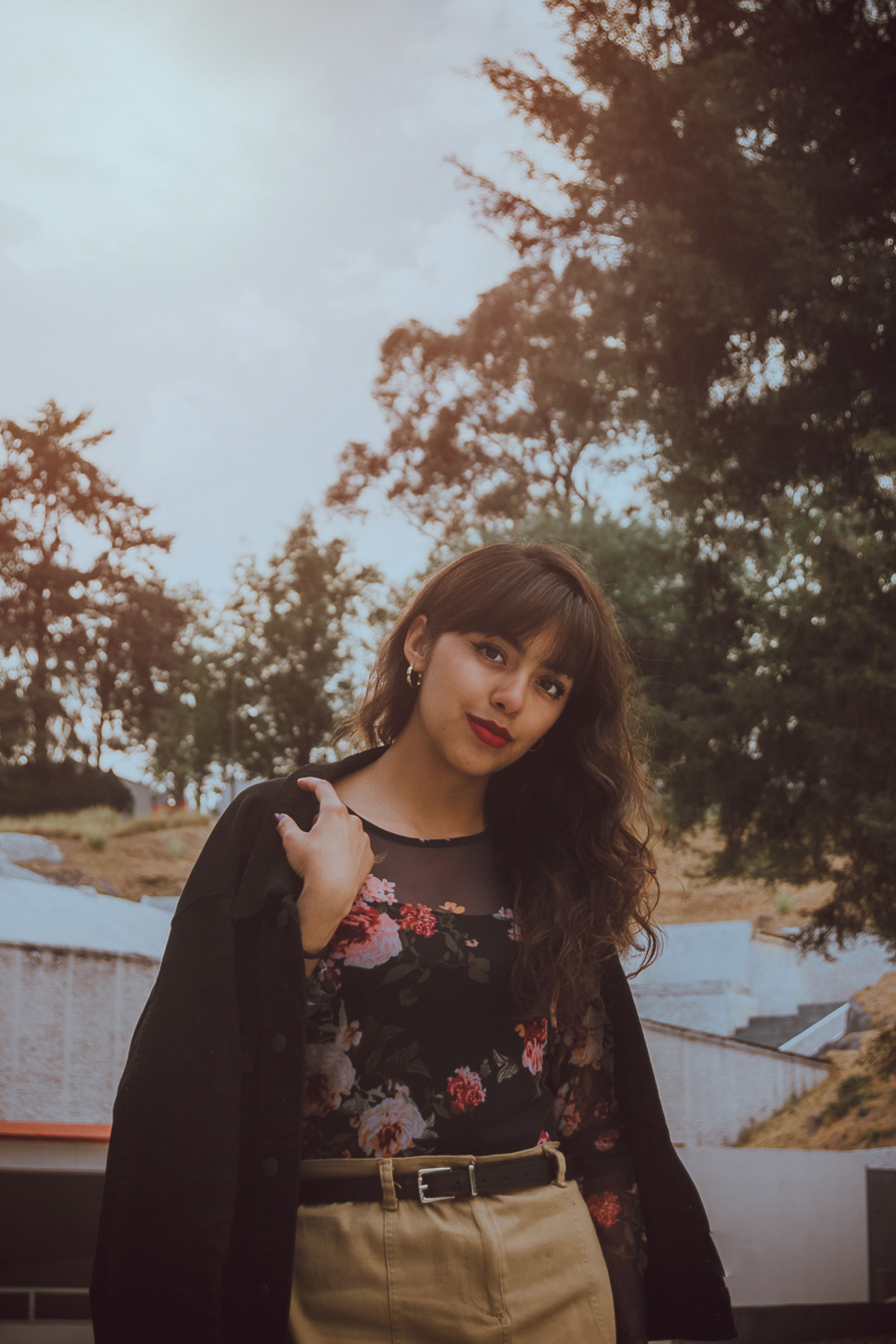Young Woman in Floral Top Outdoors · Free Stock Photo