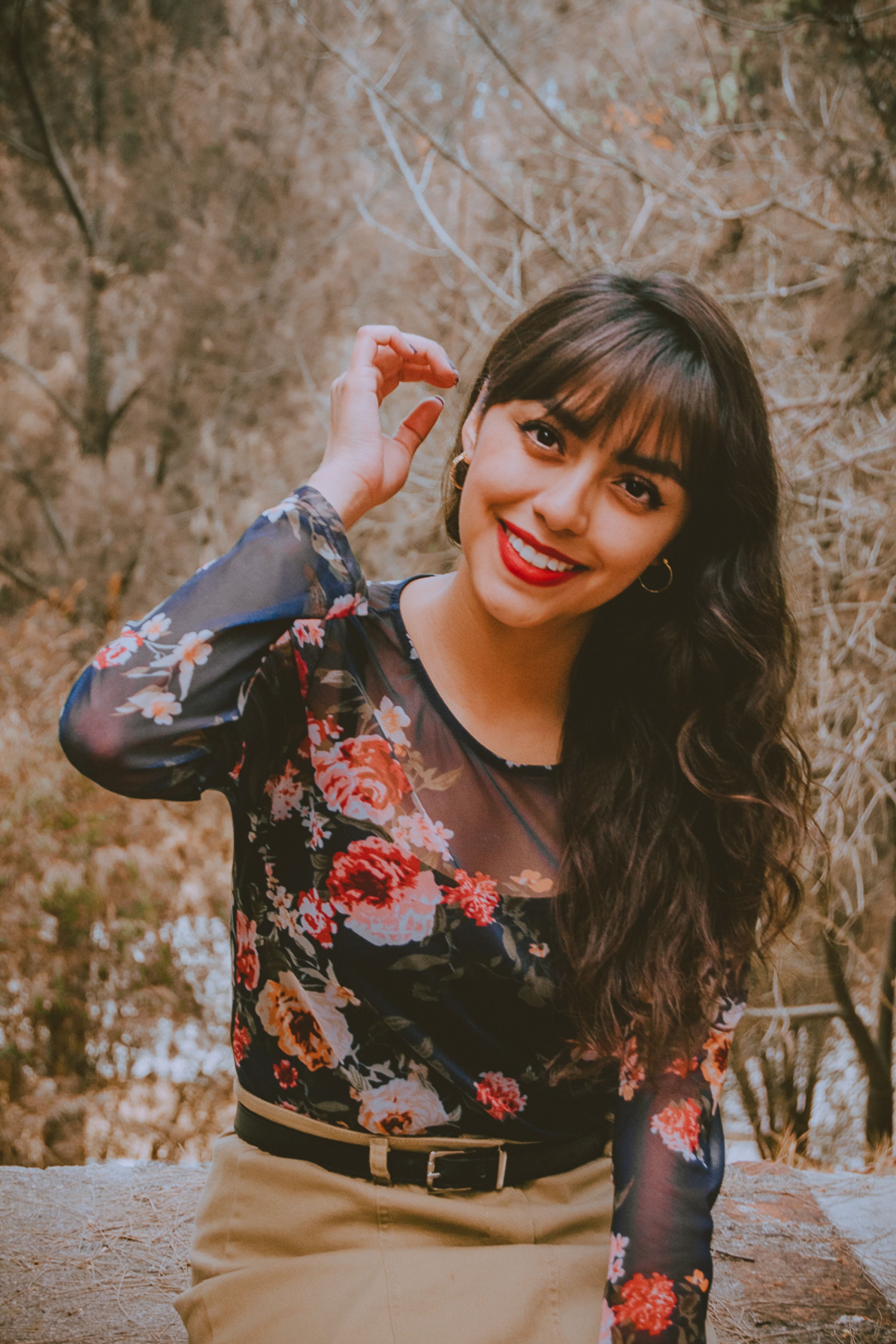 Smiling Woman in Floral Blouse Outdoors · Free Stock Photo