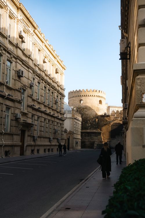 Free Charming street view capturing medieval architecture in Baku, Azerbaijan at sunset. Stock Photo