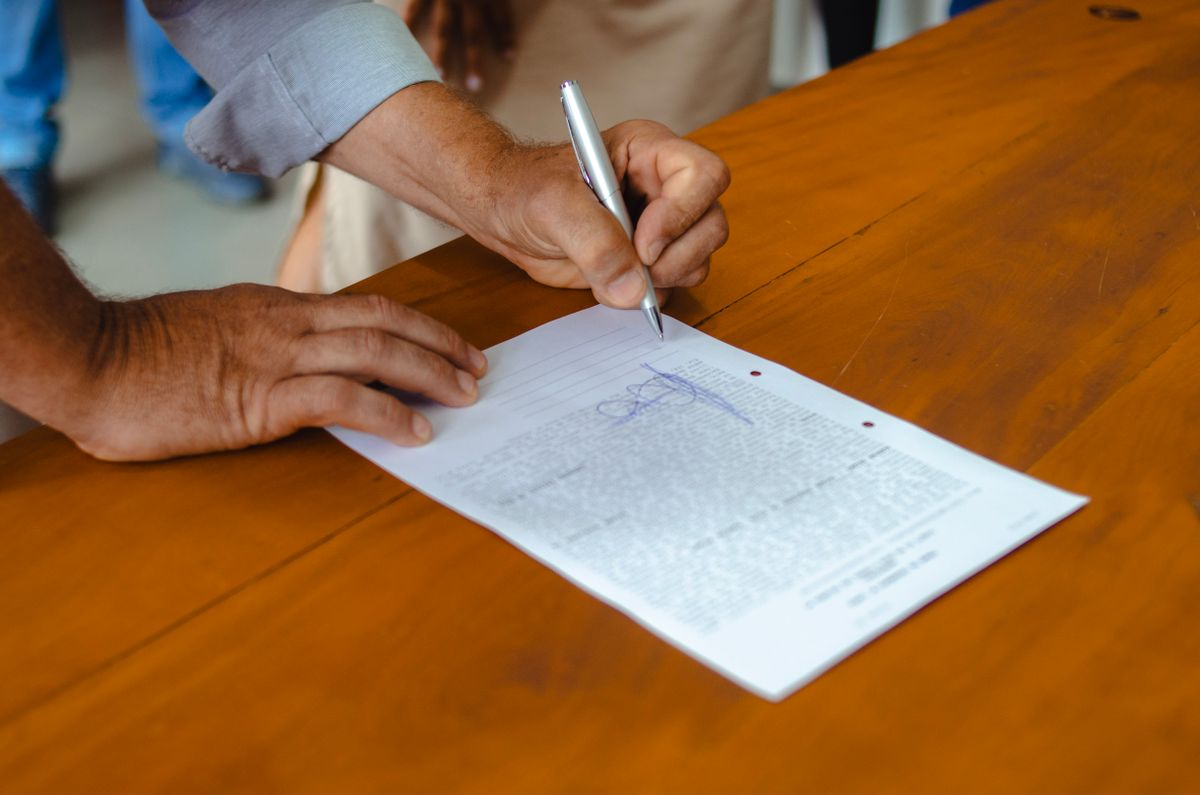 Person Holding Silver Pen Signing Photographers Signature · Free Stock ...