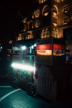 Illuminated popcorn stand on a dimly lit street in Baku, Azerbaijan.