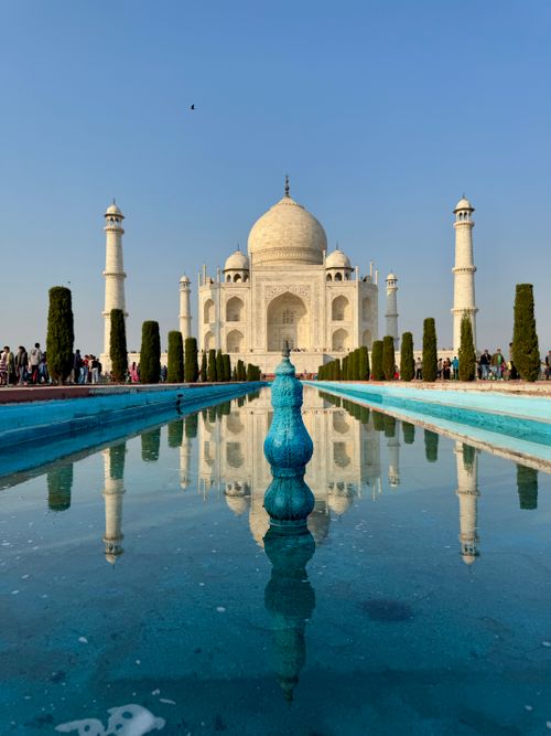 Free The stunning Taj Mahal reflected in the water, showcasing its grandeur under a clear blue sky. Stock Photo