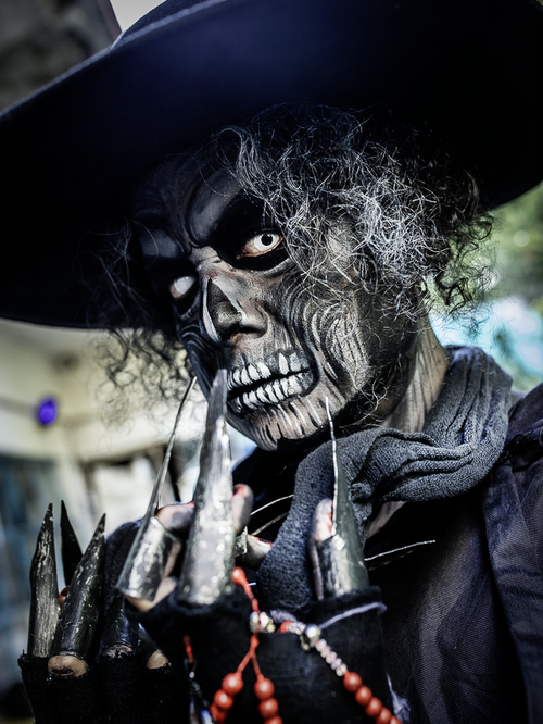 Free Eerie Halloween makeup and claws create a haunting character effect. Stock Photo