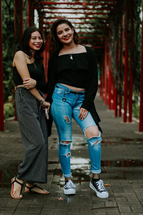 Smiling Women Standing on Bridge