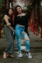 Smiling Women Standing on Bridge