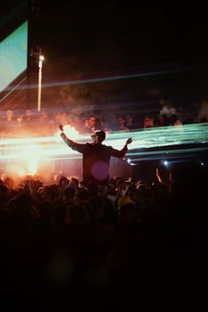 Exciting night concert scene with enthusiastic crowd enjoying the show.