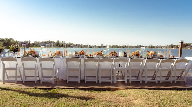 Beautifully set outdoor wedding reception by a lake in New Orleans.