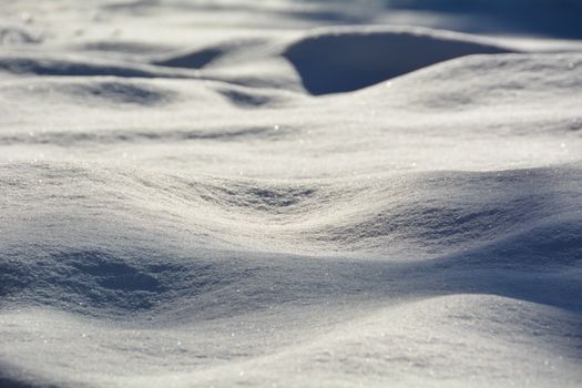 Explore the tranquil beauty of a sunlit snowy landscape capturing the serene textures of winter.
