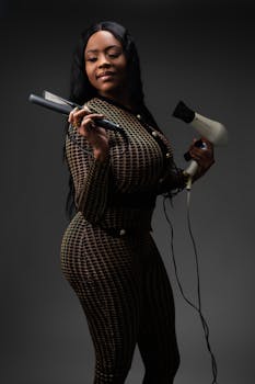 Elegant African American woman holding hair styling tools in New Orleans.