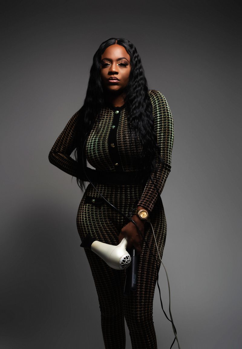 Long, smooth pressed hair with a dryer in hand
