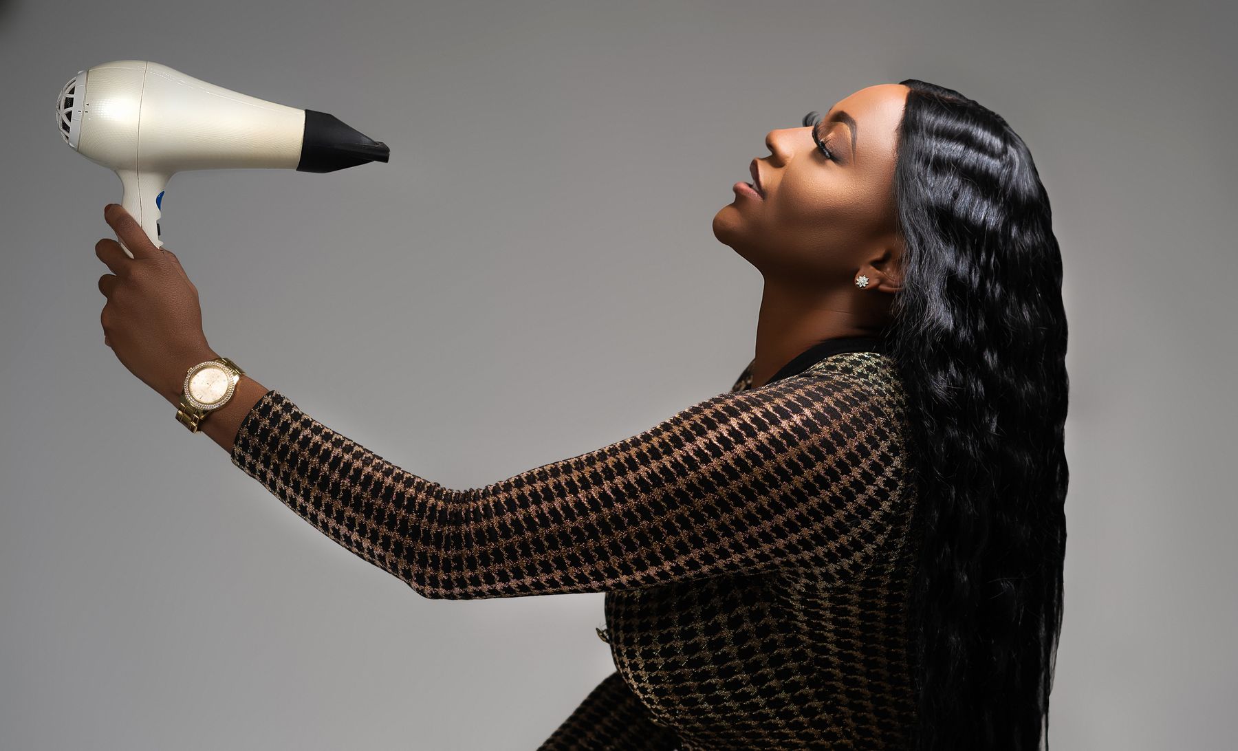 Woman styling her long hair with a blow dryer