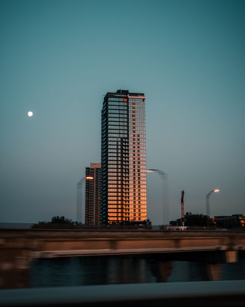 Free Modern skyscraper in Montreal reflecting sunset colors, captured at dusk with a serene sky. Stock Photo