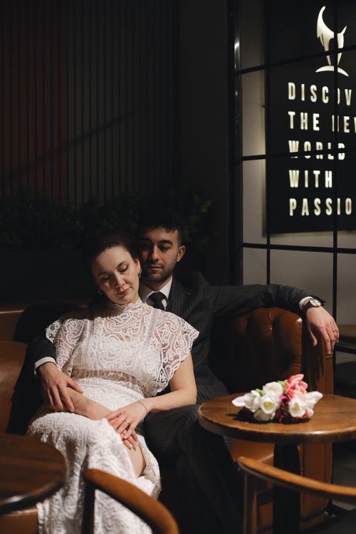Free A couple in elegant attire sharing a quiet, intimate moment indoors. Stock Photo