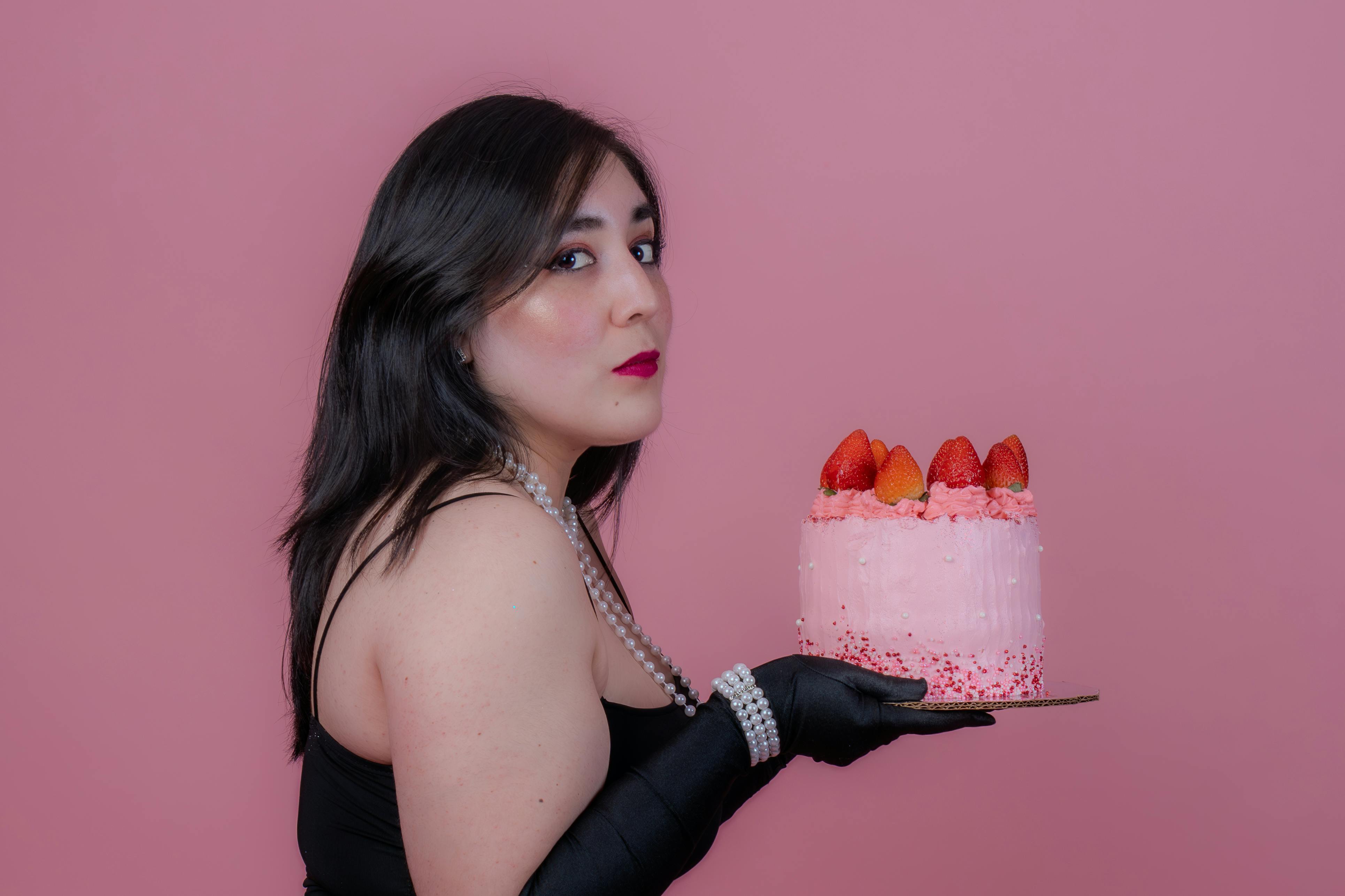elegant woman holding strawberry cake in mexico