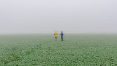 Photo of People Standing on Grass Field