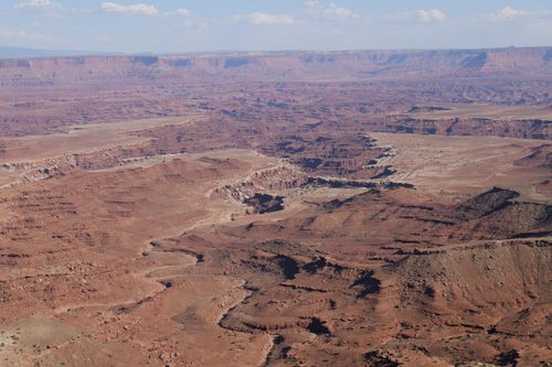 Free Stunning aerial view of a vast, rugged canyon under a clear blue sky. Stock Photo