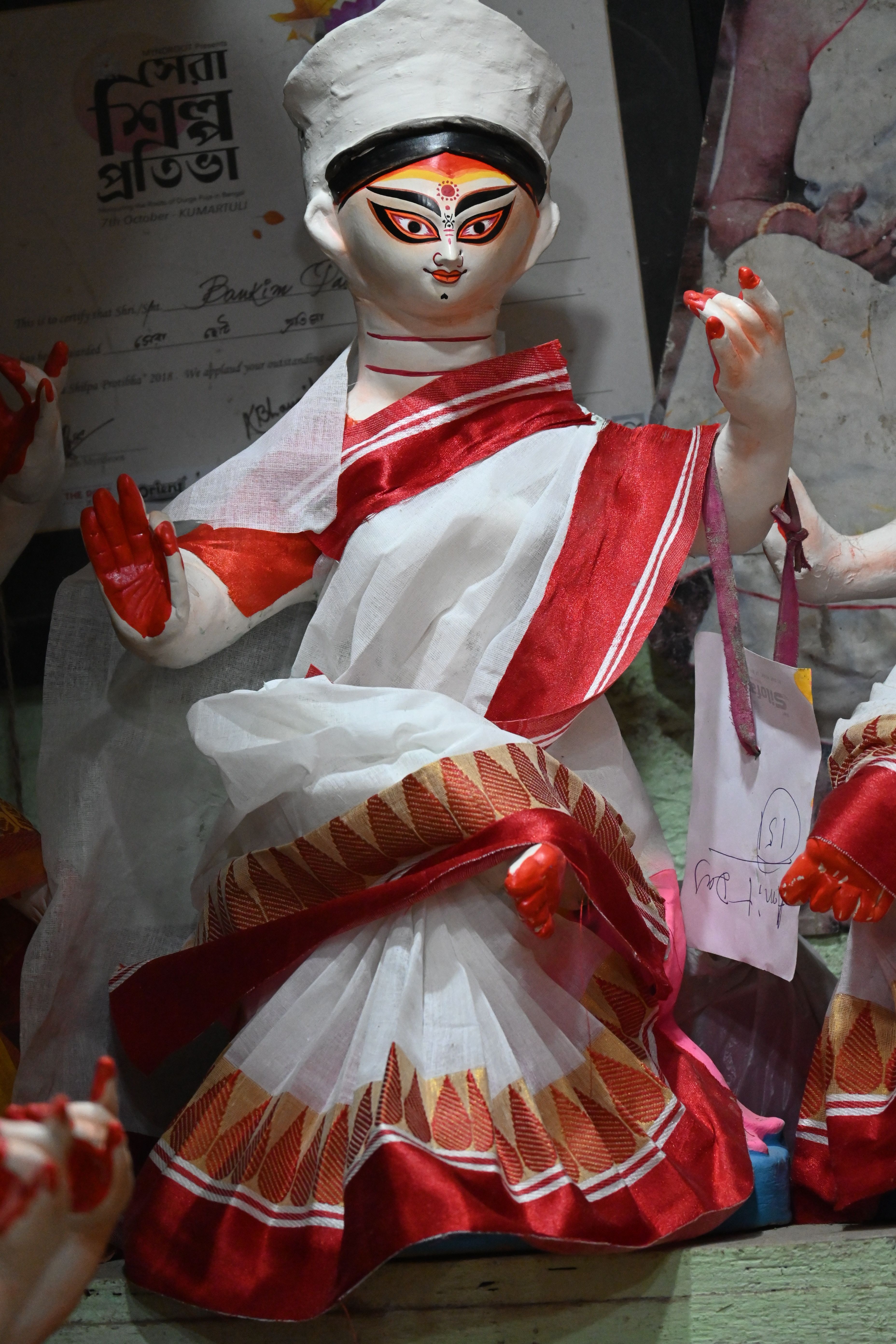 A vibrant handcrafted doll in traditional attire from Kolkata, India, showcasing cultural artistry.