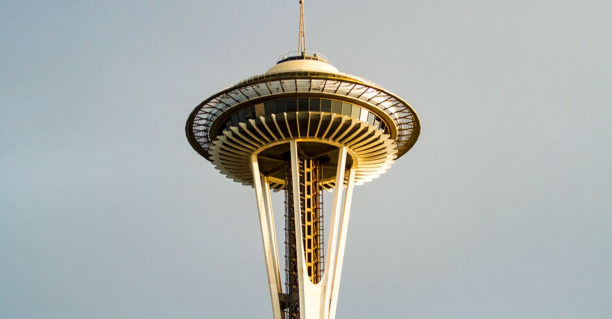 Close-up view of the Space Needle against a clear sky in Seattle.