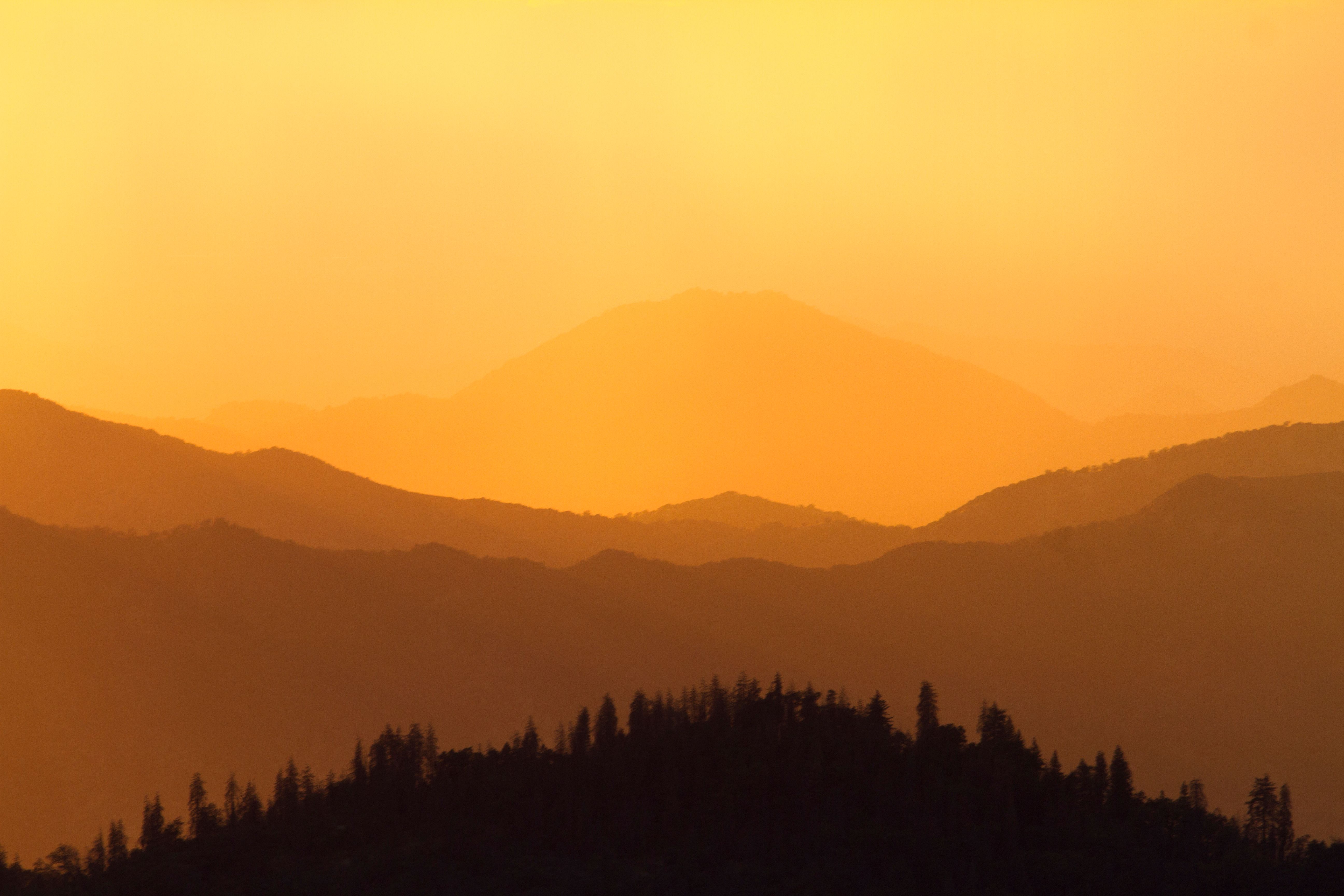 Breathtaking view of layered mountains at sunset in California, USA.