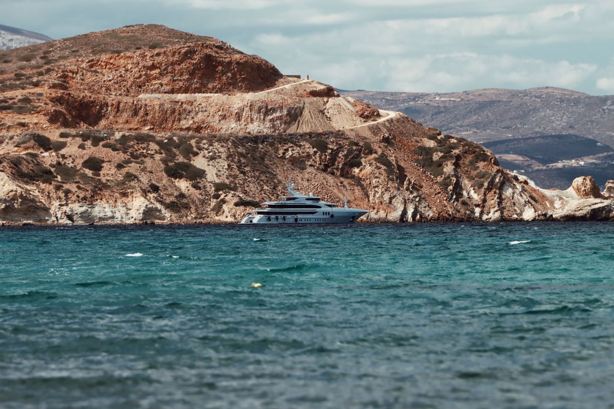 A yacht anchored off the Greek cliffs