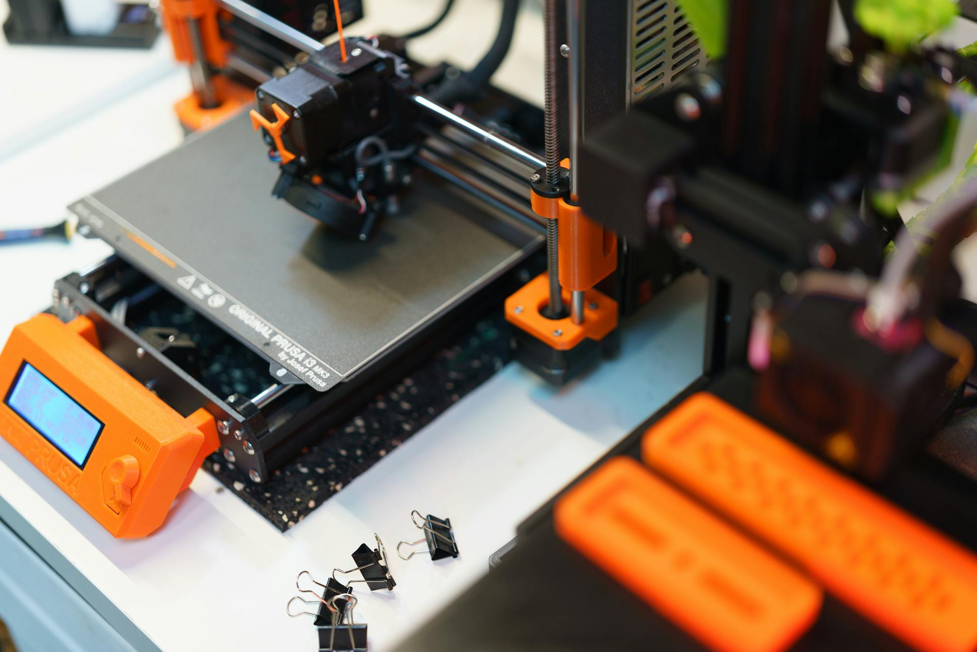 Detailed view of a 3D printer in a modern industrial setting, showcasing technology and creativity.