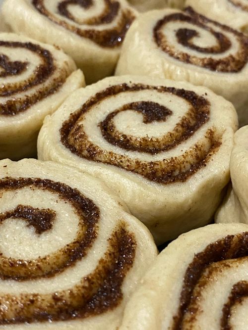 Free Delicious freshly baked cinnamon rolls with sweet cinnamon swirl detail. Stock Photo