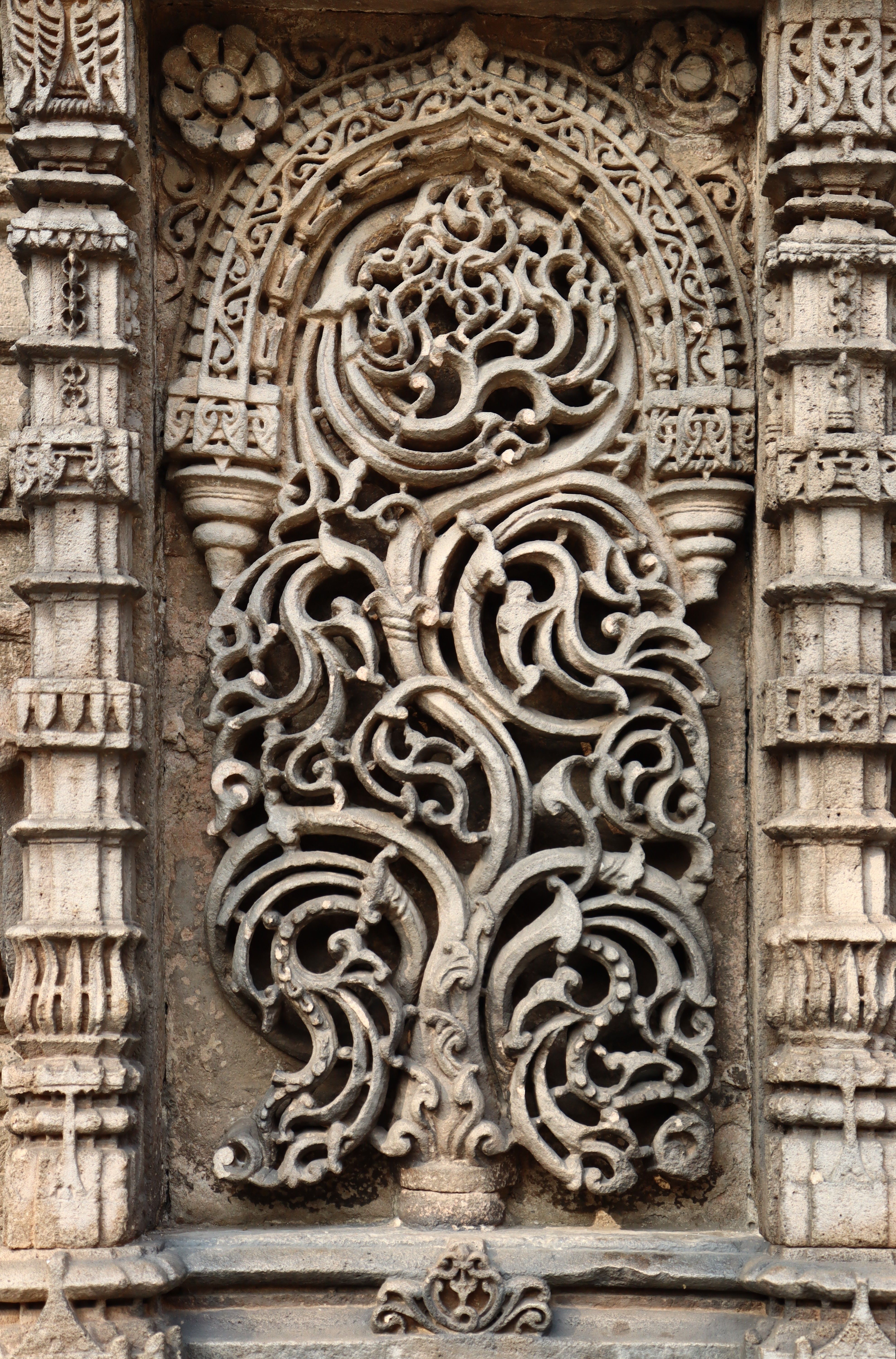 Detailed stone carving in Indian architecture showcasing intricate design.
