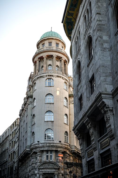 Free Elegant historic building with a green dome roof in a cityscape setting. Perfect for architecture enthusiasts. Stock Photo