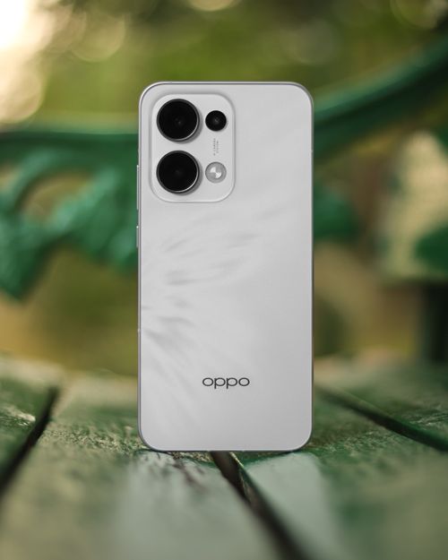 Free White smartphone on wooden bench with blurred green background, symbolizing nature and technology fusion. Stock Photo