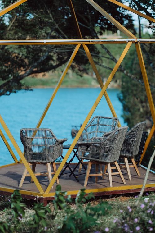 Free Geodesic dome with wicker chairs by a serene lake, perfect for relaxation. Stock Photo