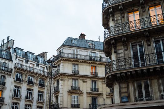 Classic Parisian buildings with intricate balconies at dusk, showcasing European charm.