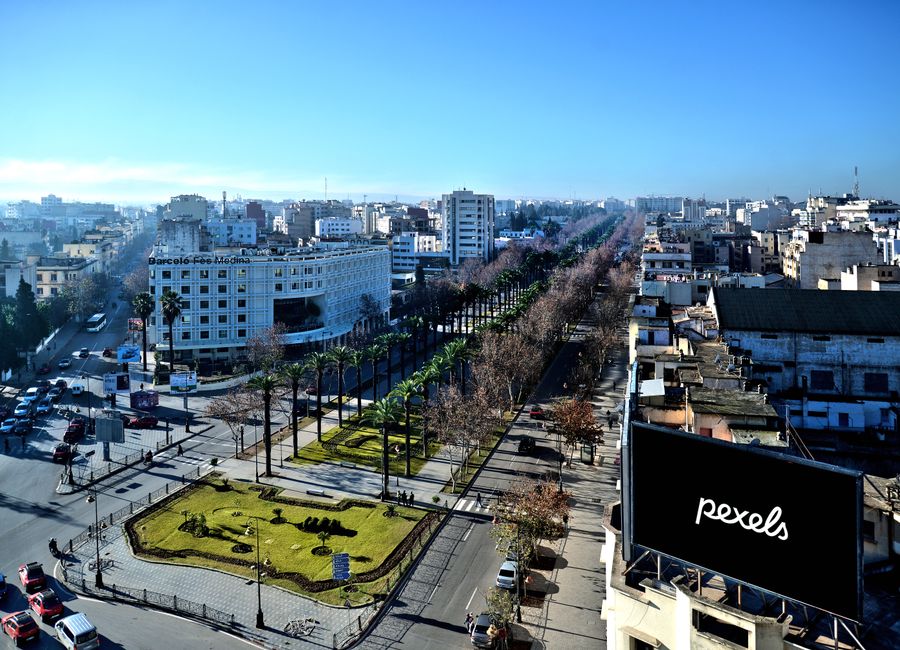 Aerial view showcasing the cityscape of Fès, Morocco, with clear skies and vibrant urban layout.