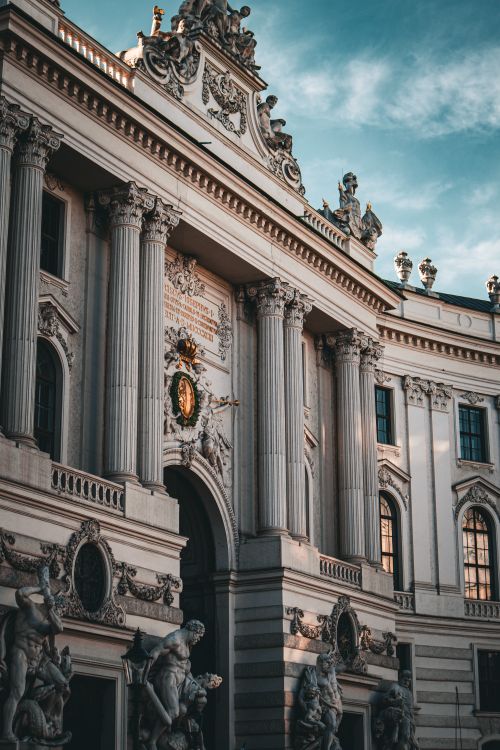Free A magnificent view of a historic baroque building facade under a clear sky. Stock Photo
