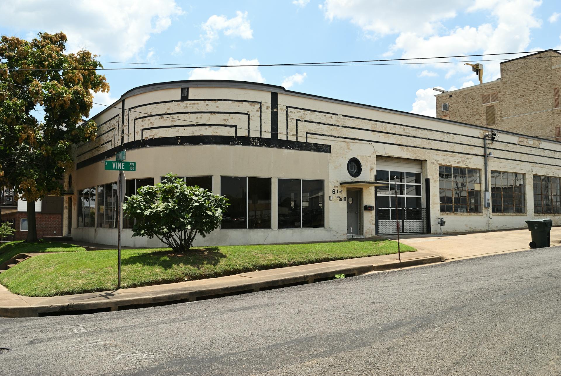 Vintage Art Deco building corner view in Tyler, Texas under a sunny sky.