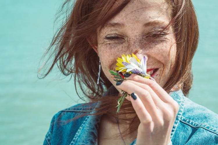 Photo Of Woman Smelling Flower