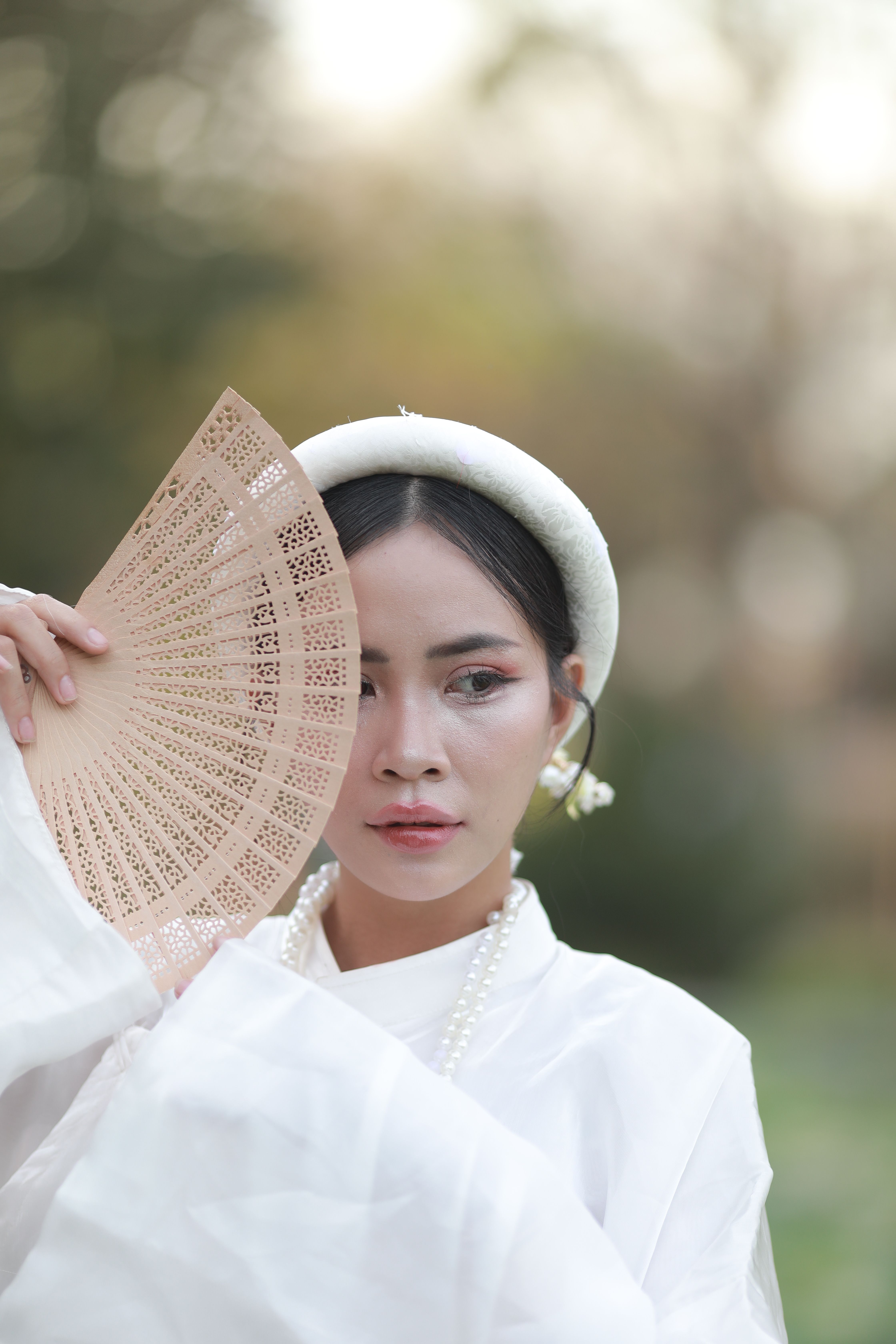 Elegant Woman with Traditional Fan Outdoors · Free Stock Photo