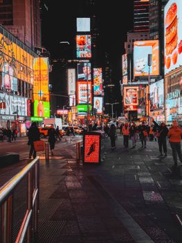 Explore the bustling nightlife of Times Square with vivid billboards and lively crowds.