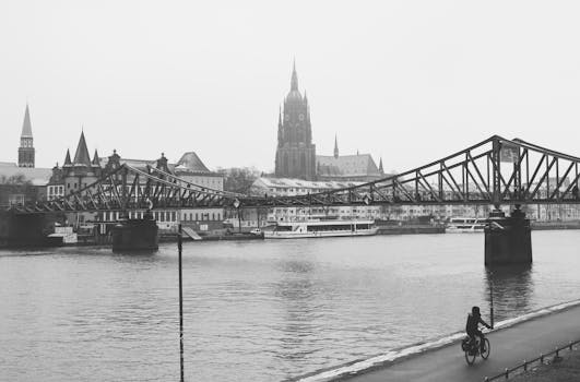 Monochrome view of the Eiserner Steg bridge and cathedral in Frankfurt, Germany.