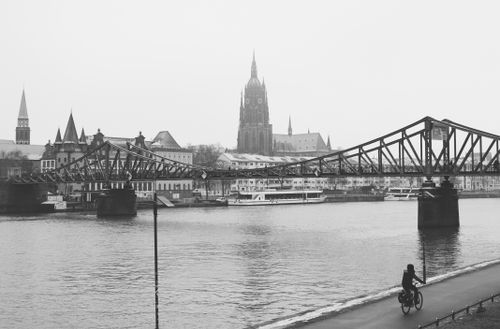 Free Monochrome view of the Eiserner Steg bridge and cathedral in Frankfurt, Germany. Stock Photo