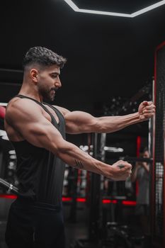 Muscular man exercising in gym with focus and determination.