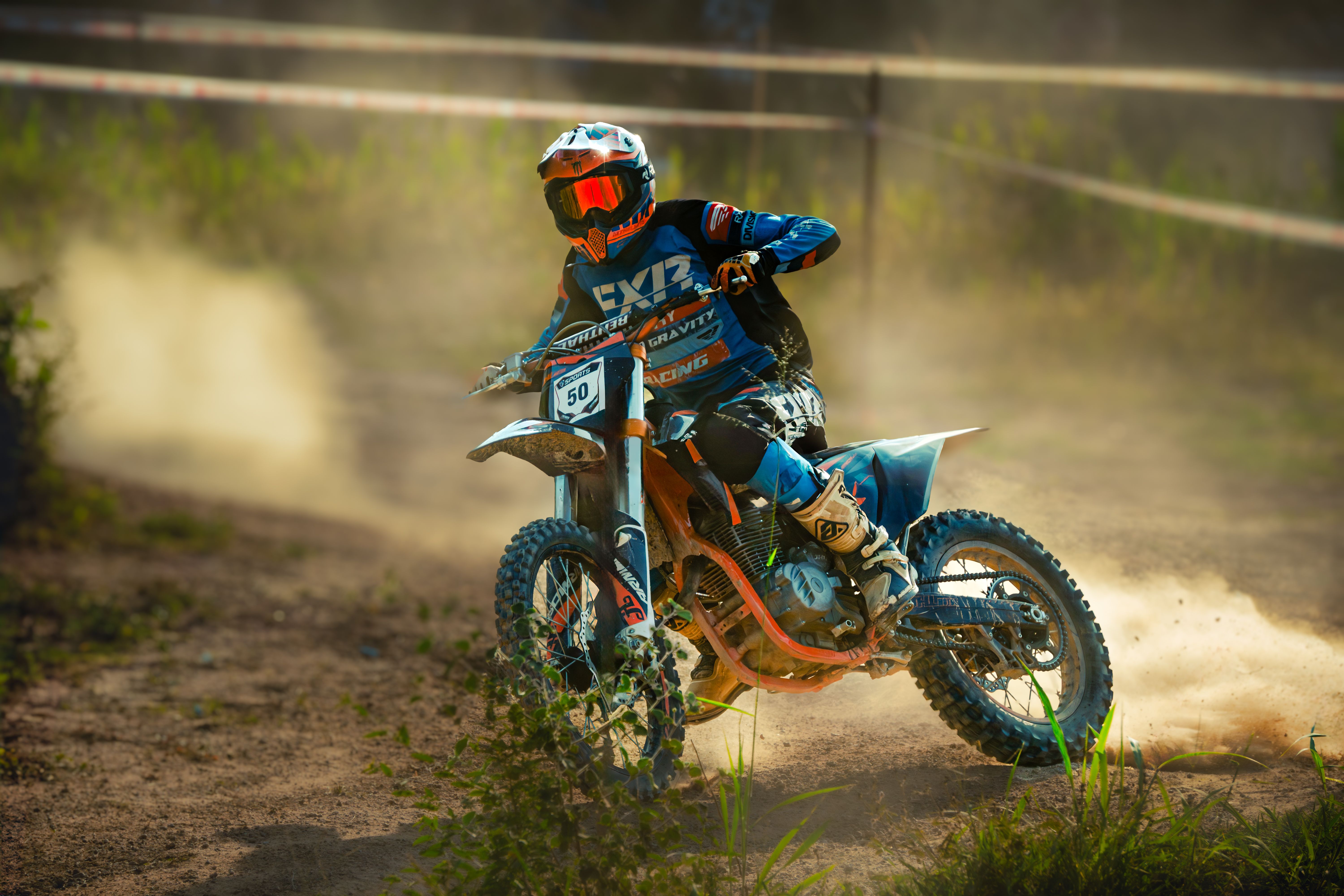 Dynamic Motocross Racer in Action on Dirt Track · Free Stock Photo